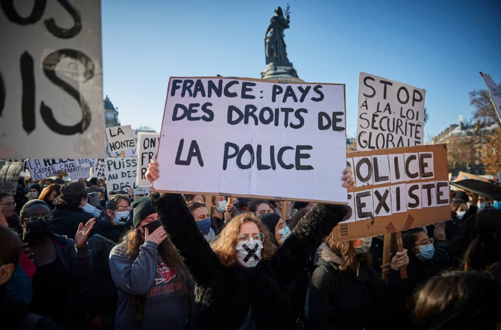 A view of people holding up placards in a protest in Paris