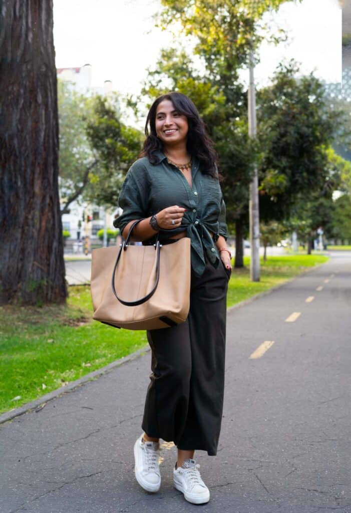 woman styling wide leg jeans holding a bag