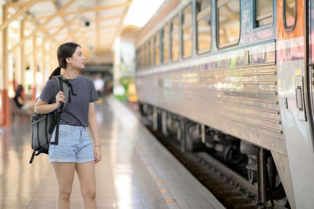 a girl standing at a train station