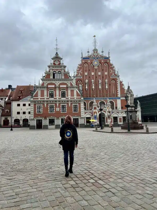 a girl walking towards the House of the Black Heads -Riga Latvia