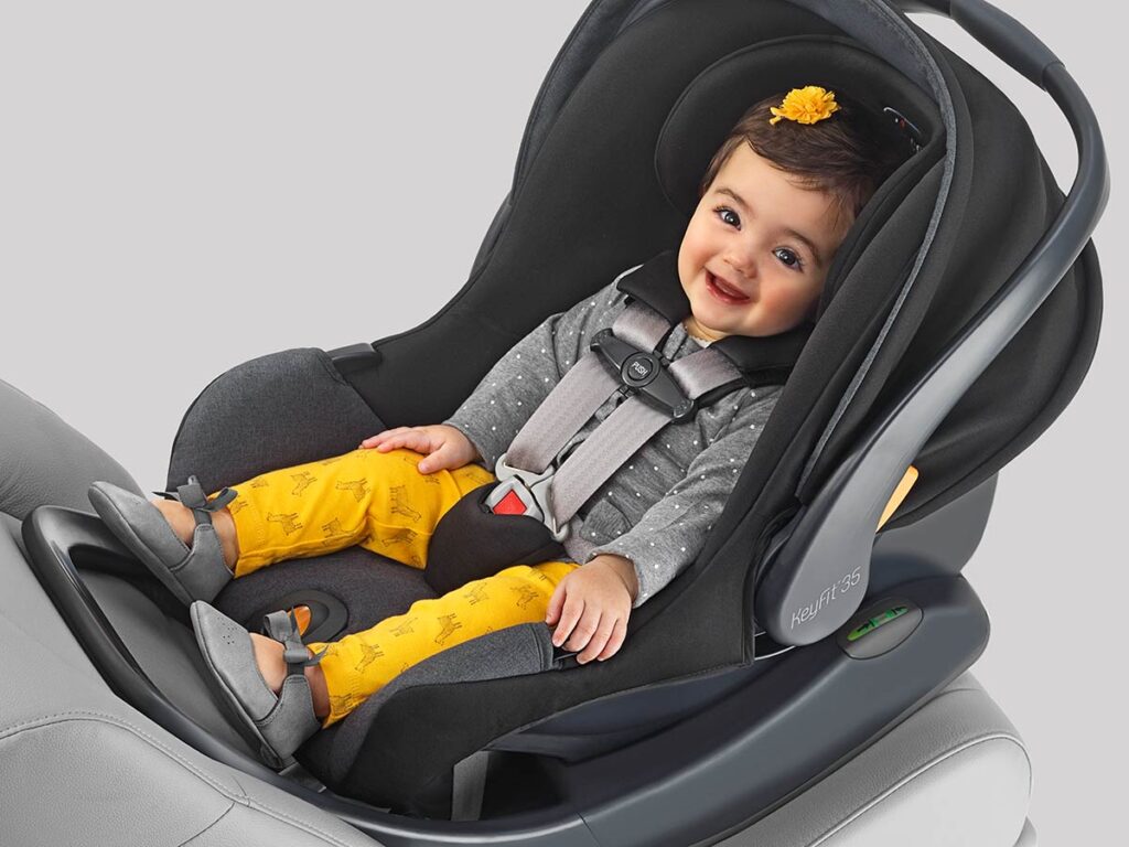 a smiling baby girl in a car seat