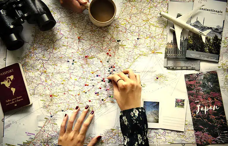 a women is pinning a location on a table map